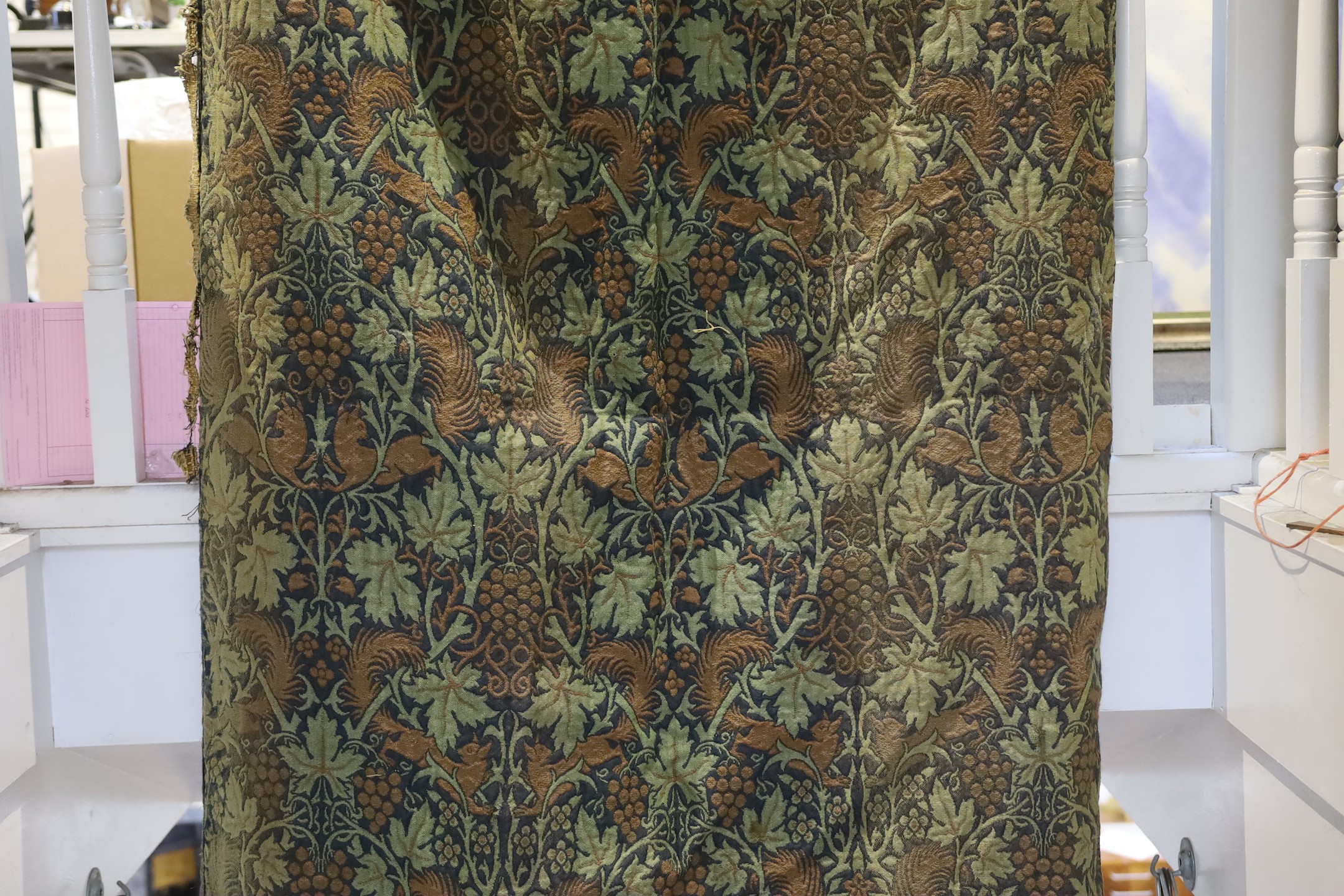 John Henry Dearle for Morris & Co. a pair of Squirrel design curtains, c.1890, hand loom woven wool at Merton Abbey, each with ornate braided edging and lining: 8ft 6ins. drop x 4ft wide each